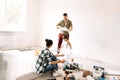 Woman with her husband and child are sitting on mattress among building materials Royalty Free Stock Photo