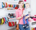Woman with her kid who are shopping in child store Royalty Free Stock Photo