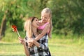 Woman and her little daughter playing in park Royalty Free Stock Photo