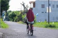 Woman on her old bicycle alone, going home after some morning ride in Yogyakarta Royalty Free Stock Photo