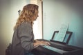 Woman and her piano in home