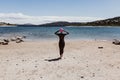 Woman in her 40s wearing a neoprene and waiting to swim in the lake. Triathlon concept