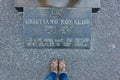 Woman with her shoes near CR7 Cristiano Ronaldo statue plaque in CR7