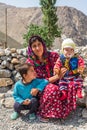 A woman with her two children in the mountains of Tajikistan