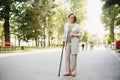 Woman with her walking stick in the park. Royalty Free Stock Photo