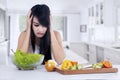 Woman hesitate to eat salad Royalty Free Stock Photo