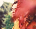 Woman with hidden face on autumn ivy leaves background Royalty Free Stock Photo