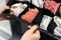 woman hides American dollars in a box of lingerie.