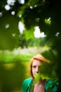 Woman hiding behind leaves