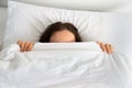 Woman hiding face under blanket Royalty Free Stock Photo