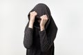 Woman hiding face under the clothes. She is oulling sweatr on her head. Depressed emotion. Royalty Free Stock Photo