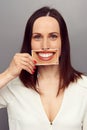 Woman hiding her emotions behind smile Royalty Free Stock Photo