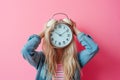 Woman hiding her face with alarm clock. Time management, schedule, deadline, time concept. Flow of time, rush and hurry, timing,