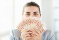 Woman hiding her face behind euro money fan Royalty Free Stock Photo