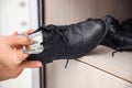 Woman hiding money in shoe indoors. Financial savings