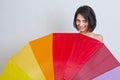 Woman hiding over colorful umbrella Royalty Free Stock Photo