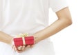 Woman hiding red gift box behind her back Royalty Free Stock Photo
