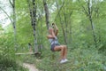 Woman on high wire climbing in adventure park Royalty Free Stock Photo