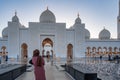 Woman in Hijab looking at a mosque at sunset | Abu Dhabi Sheik Zayed Mosque | Beautiful islamic architecture | Tourist attraction