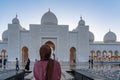 Woman in Hijab looking at a mosque at sunset | Abu Dhabi Sheik Zayed Mosque | Beautiful islamic architecture | Tourist attraction