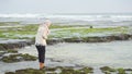 A woman hijab play water in beach, Drini beach, Yogyakarta,