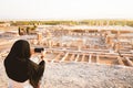 Woman in hijab travel take photo of Persepolis panorama- ancient persian city remains