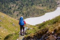 Woman hike with backpack at the lake of highlands of Altai mount