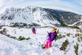 Woman hikeing in the snowy mountains with a phone and snowshoes. and backpack