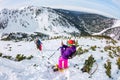 Woman hikeing in the snowy mountains with a phone and snowshoes. and backpack Royalty Free Stock Photo