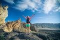 Woman hiker with arms outstretched enjoy mountains