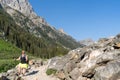 Woman hiker with a backpack on the Cascade Canyon trail in Grand Teton National Park. Left aligned, room for copyspace Royalty Free Stock Photo