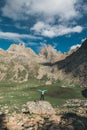 Woman hiker with backpack hiking on high altitude mountain Royalty Free Stock Photo