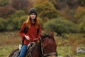 woman hiker with backpack rides a horse friendship travel mountains Royalty Free Stock Photo