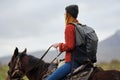 woman hiker with backpack riding horse travel freedom Royalty Free Stock Photo