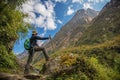 Woman hiker with backpack standing on the rock enjoy mountain view Annapurna ,Nepal.