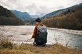 woman hiker with backpack travel river mountains landscape walk