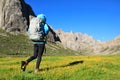 hiker with backpack walking on high altitude mountains Royalty Free Stock Photo