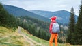 Woman hiker with backpack walking outdoors in mountains Royalty Free Stock Photo