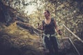 Woman hiker with backpack walking on the wild track in mountain forest. Royalty Free Stock Photo