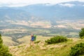 Hiker with big backpack stands on the rock and enjoys the valley view in Spanish Pyrenees mountains Royalty Free Stock Photo