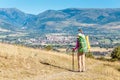 Hiker with big backpack stands on the rock and enjoys the valley view in Spanish Pyrenees mountains Royalty Free Stock Photo