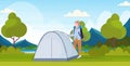 Woman hiker camper installing a tent preparing for camping hiking concept traveler on hike beautiful nature landscape