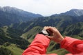 Woman hiker checking the altimeter on sports watch at mountain peak Royalty Free Stock Photo