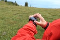 Woman hiker checking the altimeter on sports watch at mountain peak Royalty Free Stock Photo