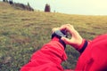 Woman hiker checking the altimeter on sports watch at mountain peak Royalty Free Stock Photo