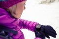 Woman hiker checking sports watch in winter woods and mountains Royalty Free Stock Photo