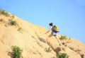 Woman hiker climbing mountain