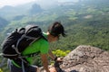 Woman hiker climbing rock on mountain peak cliff Royalty Free Stock Photo