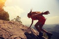 Woman hiker climbing rock on mountain peak cliff Royalty Free Stock Photo