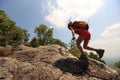 Woman hiker climbing rock on mountain peak cliff Royalty Free Stock Photo